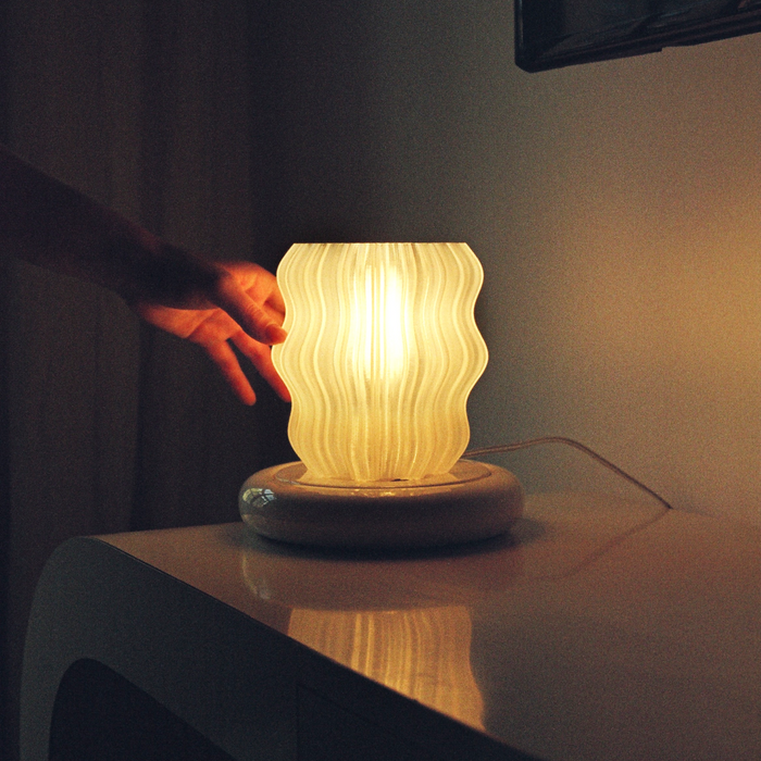 Mini wavy lamp by Wooj Design featuring a sleek, modern design with a wavy shape and soft lighting effect.