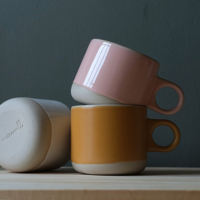 Pink and gold dipped Scotty tumbler mug by Misewell with a glossy finish and sleek design, perfect for beverages.